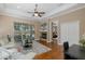 Bright living room with hardwood floors, fireplace, and sliding glass doors to the lanai and pool at 502 Creekside Ct, Safety Harbor, FL 34695
