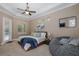 Serene main bedroom with tray ceilings, ensuite door, and backyard access at 502 Creekside Ct, Safety Harbor, FL 34695