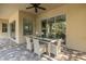 Covered patio with dining table, offering a stylish outdoor dining area at 502 Creekside Ct, Safety Harbor, FL 34695