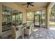 Covered patio with dining table and access to the pool area, perfect for outdoor entertaining at 502 Creekside Ct, Safety Harbor, FL 34695