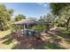 Aerial view of a screened-in pool and lush backyard, surrounded by mature landscaping at 502 Creekside Ct, Safety Harbor, FL 34695