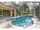 Lovely screened-in pool and spa with lush landscaping and outdoor seating at 502 Creekside Ct, Safety Harbor, FL 34695