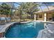 Stunning screened-in pool with waterfall feature and outdoor seating area at 502 Creekside Ct, Safety Harbor, FL 34695