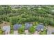 Aerial shot showcases homes with pools and solar panels amid mature trees, offering a private and eco-friendly lifestyle at 5109 Hartwell Loop, Land O Lakes, FL 34638