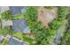 Aerial view of home featuring a pool, solar panels, and a lush, green landscape at 5109 Hartwell Loop, Land O Lakes, FL 34638