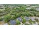 Beautiful aerial view of neighborhood homes with pools and lush landscaping near a wooded area at 5109 Hartwell Loop, Land O Lakes, FL 34638