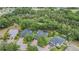 Aerial view of homes with swimming pools surrounded by lush trees in a well-maintained neighborhood at 5109 Hartwell Loop, Land O Lakes, FL 34638