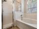 Bathroom featuring shower, soaking tub, tiled walls, and a window to let in natural light at 5109 Hartwell Loop, Land O Lakes, FL 34638
