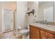 Charming bathroom features a granite countertop, wood vanity and a shelf for extra storage or decor at 5109 Hartwell Loop, Land O Lakes, FL 34638