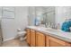 Bright bathroom featuring a single vanity, a toilet, and a shower with a patterned curtain at 5109 Hartwell Loop, Land O Lakes, FL 34638