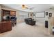 Spacious upstairs bonus room with theater screen, desk, and built-in shelving at 5109 Hartwell Loop, Land O Lakes, FL 34638