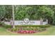 Elegant entrance sign for Lake Talia, a deed-restricted community with manicured landscaping and colorful flowers at 5109 Hartwell Loop, Land O Lakes, FL 34638