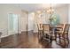 Inviting dining room features hardwood floors, elegant chandelier, and arched entryway at 5109 Hartwell Loop, Land O Lakes, FL 34638