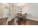 Inviting dining room boasts hardwood floors, chandelier, and arched window at 5109 Hartwell Loop, Land O Lakes, FL 34638
