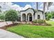 Charming home featuring a manicured lawn, arched entryway, and lush landscaping for enhanced curb appeal at 5109 Hartwell Loop, Land O Lakes, FL 34638