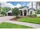Charming single-story home with arched entry, well-manicured landscaping, and a brick driveway at 5109 Hartwell Loop, Land O Lakes, FL 34638