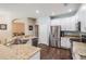 Open kitchen with granite countertops, stainless appliances, and a breakfast bar at 5109 Hartwell Loop, Land O Lakes, FL 34638
