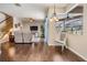 Open-concept living room with hardwood floors, ceiling fans, and access to screened-in patio at 5109 Hartwell Loop, Land O Lakes, FL 34638