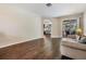 Bright and airy living room with hardwood floors and view of the screened-in porch at 5109 Hartwell Loop, Land O Lakes, FL 34638
