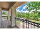 View from balcony with black metal railings and stone pillars that overlooks a street with parked cars at 5117 Longspur Ct, Lithia, FL 33547