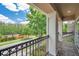 View from the balcony with black metal railings and stone pillars that overlooks the street and greenery at 5117 Longspur Ct, Lithia, FL 33547