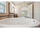 Bathroom featuring soaking tub, and sinks and a view into the main bedroom at 5117 Longspur Ct, Lithia, FL 33547