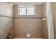 Bathroom showcasing tiled shower and window at 5117 Longspur Ct, Lithia, FL 33547