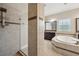 Bathroom featuring walk-in shower and soaking tub at 5117 Longspur Ct, Lithia, FL 33547