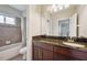Bathroom showcasing tiled shower, tub, and granite counters at 5117 Longspur Ct, Lithia, FL 33547