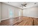 Bedroom featuring hardwood floors, ceiling fan and two sets of doors at 5117 Longspur Ct, Lithia, FL 33547