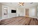 Spacious bedroom showcasing wood floors, a ceiling fan, and an en suite bathroom at 5117 Longspur Ct, Lithia, FL 33547