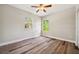 Bedroom showcasing wood floors, neutral walls, and windows at 5117 Longspur Ct, Lithia, FL 33547
