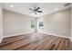 Bedroom featuring hardwood floors, ceiling fan and two windows at 5117 Longspur Ct, Lithia, FL 33547