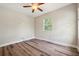 Empty bedroom featuring wood floors, ceiling fan, one window, and neutral paint at 5117 Longspur Ct, Lithia, FL 33547