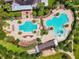 Aerial view of a resort-style community pool with ample seating, palm trees, and Gathering-friendly water features at 5117 Longspur Ct, Lithia, FL 33547