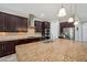 This kitchen features dark wood cabinets, granite countertops, stainless steel appliances and a large kitchen island at 5117 Longspur Ct, Lithia, FL 33547