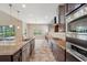 Gourmet kitchen featuring granite countertops, stainless steel appliances, and ample cabinet space at 5117 Longspur Ct, Lithia, FL 33547