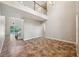 Open-concept living room with soaring ceilings, tile flooring, staircase, and views of the pool at 5117 Longspur Ct, Lithia, FL 33547