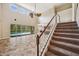 Open-concept living area with high ceilings, a staircase, and views of the pool at 5117 Longspur Ct, Lithia, FL 33547