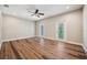 The living room features stylish wood flooring, ceiling fan, and two glass doors with outside access at 5117 Longspur Ct, Lithia, FL 33547