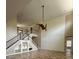 Open-concept living room featuring high ceilings, paneled walls, decorative elements, and stairway access at 5117 Longspur Ct, Lithia, FL 33547