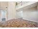 Spacious living room with soaring ceilings, tile flooring, and a second-story railing at 5117 Longspur Ct, Lithia, FL 33547