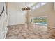 Open-concept living space with a feature wall, soaring ceilings, and sliding glass doors leading to a pool area at 5117 Longspur Ct, Lithia, FL 33547