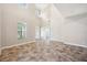 Expansive living room with soaring ceilings, large windows, and a decorative tile floor at 5117 Longspur Ct, Lithia, FL 33547