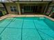 Clear, blue pool with patio, screened walls, and ceiling fans on a covered area for shade at 5117 Longspur Ct, Lithia, FL 33547