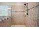 Tiled walk-in shower featuring neutral tilework, glass enclosure, and a sleek showerhead at 5117 Longspur Ct, Lithia, FL 33547