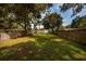 Long backyard with a wooden fence and lush green grass, enclosed for privacy and perfect for outdoor activities at 5527 Kelly N Dr, St Petersburg, FL 33703
