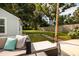Inviting backyard with a spacious lawn, lush trees, a cozy patio set, and charming stepping stones through the yard at 5527 Kelly N Dr, St Petersburg, FL 33703
