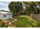 A charming backyard featuring a shed, a lush green lawn, and stepping stones leading through the well-maintained landscaping at 5527 Kelly N Dr, St Petersburg, FL 33703