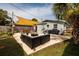 Spacious backyard with outdoor seating, grill, and sun shade providing a relaxing retreat at 5527 Kelly N Dr, St Petersburg, FL 33703
